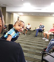 Daddy boot camp // Expectant fathers get lessons on fatherhood during a Boot Camp for New Dads last Saturday at Chippenham Hospital in South Side. Sponsored by the Relationship Foundation of Virginia, the session provided dads-to-be with practical tips from new dads and their youngsters on a host of things, including how to change and dress a baby. Top left, Kenneth Jackson Jr. of Midlothian, holding his 7-month-old son, Nasir, serves as an “expert” during the session.

