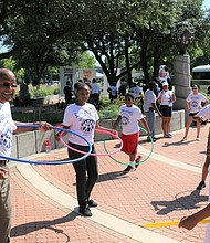 Commissioner Rodney Ellis joins youth in the Hula Hoop demonstration at the Harris County Street Olympics Summer Games kick-off on June 7.