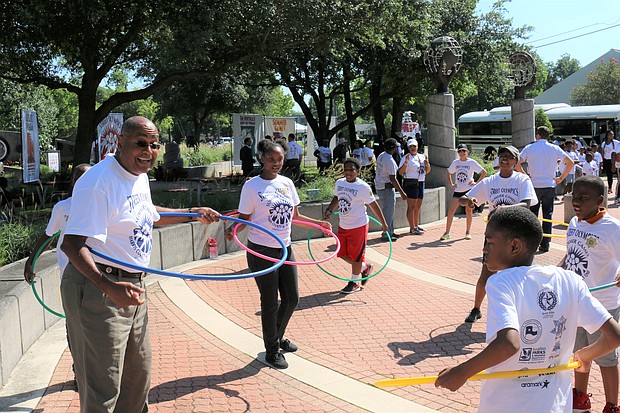 Commissioner Rodney Ellis joins youth in the Hula Hoop demonstration at the Harris County Street Olympics Summer Games kick-off on June 7.