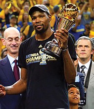 Kevin Durant of the Golden State Warriors celebrates after winning the MVP Award on Monday after Game 5 of the NBA finals at Oracle Arena in Oakland, Calif.