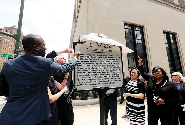 From left, Richmond Mayor Levar M. Stoney, Gov. Terry McAuliffe, Sen. Jennifer L. McClellan, Sen. Rosalyn R. Dance and ACLU of Virginia Executive Director Claire Guthrie Gastañaga help unveil the new state marker outside the Patrick Henry Building at 11th and Broad streets.