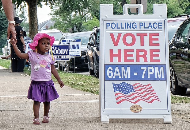 Voter in training// 
Zahria Blocker, 17 months, accompanies her grandfather, Levonne Johnson, to the voting precinct on Tuesday so he could cast his ballot in the primary election. The youngster is getting early lessons on the importance of voting. Location: 31st Street Baptist Church in the East End.  