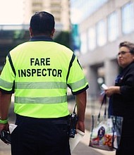 METRO fare inspector speaks to passengers on rail platform. Photo Credit: Nijalon Dunn/ METRO