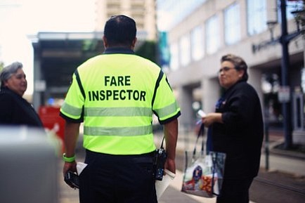 METRO fare inspector speaks to passengers on rail platform. Photo Credit: Nijalon Dunn/ METRO