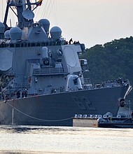 The damaged USS Fitzgerald returns to port in Yokosuka following a collision with a merchant vessel.