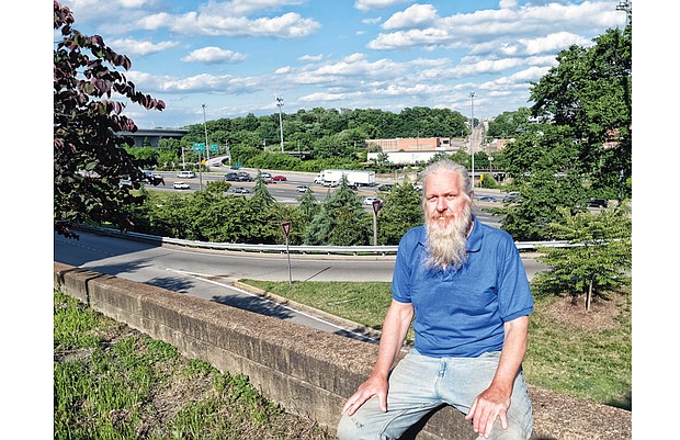 Daniel Kingery sits along Broad Street in Downtown, overlooking the 14th Street entry to Interstate 95, where he was arrested in April. 