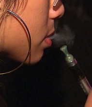 A Vaporizer pen sits on a countertop. Pens are used while vaping, or inhaling water vapor. Vaping is seen as an alternative to smoking.