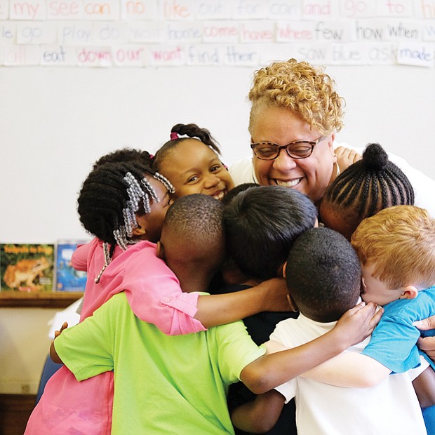 A hug to last through summer // Richmond’s J.E.B. Stewart Elementary School Principal Jennifer Moore gives kindergartners a big group hug last Friday, the last day of school. She reminded students to keep in mind her motto during the summer break: “Read, read, read.” During the summer, many students forget some of what they have learned during the school year. Called the “summer slide,” research indicates that reading just six books during the summer can help prevent loss of progress in reading.
