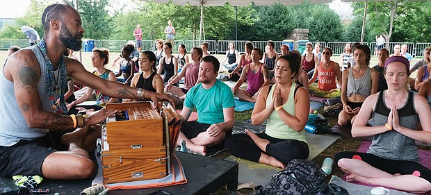 Relax, relate, release // Hundreds of people relax their minds and their bodies during the inaugural Peace Love RVA Yoga Festival last Saturday on Brown’s Island on the riverfront in Downtown. The grassroots festival, started by two Richmond friends, offered a day of music, food and free yoga classes led by some of the area’s top instructors for people at all levels. Bottom photo, Yogi Jonathan Miles starts his class with meditation
