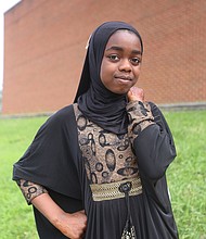 Nahla El Zubair of Richmond waits for her mother outside the festivities.