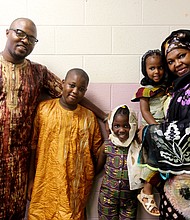 The Jondot family of Midlothian joins the celebration at the Arthur Ashe Jr. Athletic Center. Henry Jondot and his wife, Fanta Jondot, are with their children, from left, Charles, 11, Emma, 7, and Jenna, 2.