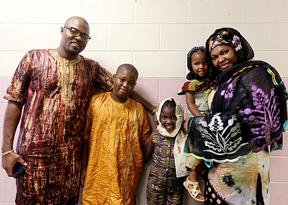 The Jondot family of Midlothian joins the celebration at the Arthur Ashe Jr. Athletic Center. Henry Jondot and his wife, Fanta Jondot, are with their children, from left, Charles, 11, Emma, 7, and Jenna, 2.