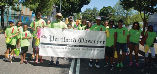 A large contingency march under the Portland Observer banner at Saturday’s Good in the Hood parade.