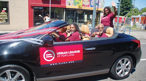Urban League of Portland officials connect with parade onlookers on Northeast Martin Luther King Jr. Boulevard.