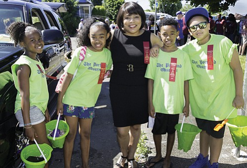 Multnomah County Commissioner Loretta Smith (center) greets Good in the Hood Parade participants Ariana Jenkins (from left), Alayah Ta, Jayden Ta and Kayden Taylor.