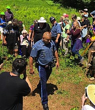 A Massachusetts State Police officer arrests longtime peace activist Frances Crowe and eight others.