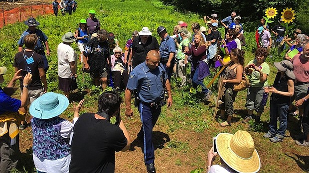 A Massachusetts State Police officer arrests longtime peace activist Frances Crowe and eight others.