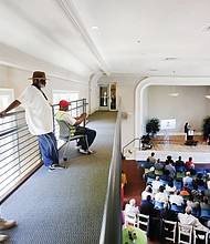 Ribbon-cutting for seniors’ new home //It took an extra five months, but the Highland Park Senior Apartments are finally finished and all 77 units are filled. The completion of the $11.4 million project was celebrated Tuesday with a ceremonial ribbon-cutting at the former elementary school building at 1221 E. Brookland Park Blvd. Richmond Mayor Levar M. Stoney and other dignitaries attended. 
From left, residents Richard Cheatham, Wilbert Curry and Jerome Hewlett watch the program from the balcony. “It’s like living in heaven,” Mr. Hewlett said of his new home.
Mr. Hewlett and other residents were relocated from Fay Towers in Gilpin Court. Washington-based Community Preservation and Development Corp. undertook this redevelopment and is working on the next two phases to raze the aging towers. 
