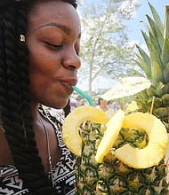 Tasting culture //
LaTeese Moore of Richmond sips a refreshing fruity drink from Jem’s Catering at the RVA Street Food Festival last Saturday at Brown’s Island. The festival, which drew hundreds of people to the city’s waterfront, offered cuisine from a variety of cultures and countries in a unique, outdoor experience.
