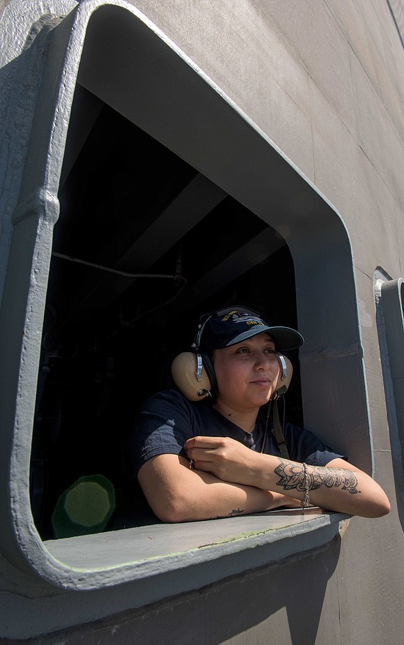 Seaman Natalie Herrera, from Houston, stands the fantail lookout watch aboard the Navy's forward-deployed aircraft carrier, USS Ronald Reagan (CVN …