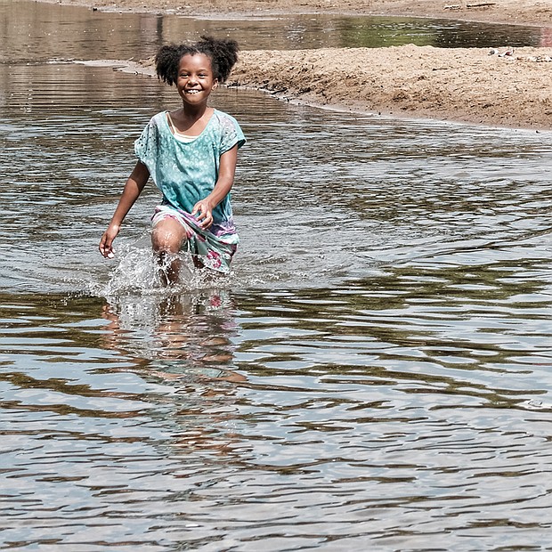 Holiday cool //
Aminah Thomas cools off in the James River during a visit with her family to the Downtown waterfront by Brown’s Island on Monday, the eve of Independence Day. Throughout the Richmond area, families enjoyed an extended holiday weekend at the river, neighborhood cookouts, local parks and to see fireworks. Please see more photos, B3.  