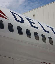 A Delta Airlines jet sits on the tarmac 