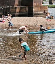 Area residents enjoy the cooling James River near Brown’s Island on Monday,