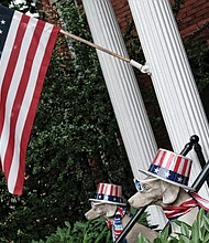 Homes and people sported the colors of the holiday. At right, the American flag flies at a house in the 2600 block of Broad Street in the East End, where dog statues also sport patriotic red, white and blue. 
