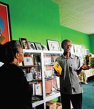 H. Khalif Khalifah, center, speaks to visitors in the Nat Turner Library in his home during last Saturday’s fundraising event, “The Resurrection of Nat Turner: Save the Land.”
