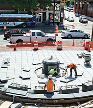Workers lay the stonework in April for the plaza at Broad and Adams streets where the statue of Richmond pioneer Maggie L. Walker will be placed.