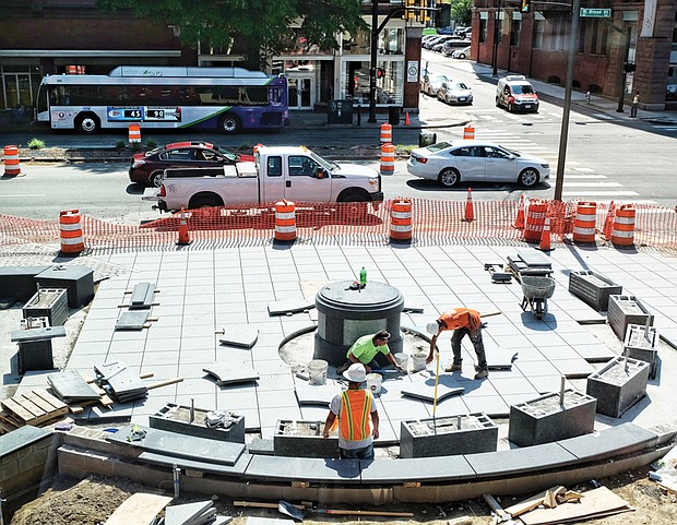 Workers lay the stonework in April for the plaza at Broad and Adams streets where the statue of Richmond pioneer Maggie L. Walker will be placed.