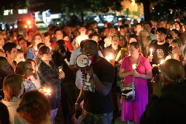 Charlottesville Vice Mayor Wes Bellamy speaks to the crowd during a candlelight gathering May 14 to counter a demonstration by white supremacists carrying torches and chanting Nazi phrases to halt the removal of Confederate statues in Charlottesville. The Charlottesville City Council voted in April to remove and sell the statue of Robert E. Lee in a Downtown park, but a judge in early May put a six-month hold on the sale. 
