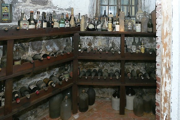 Museum workers in New Jersey broke through a Prohibition-era wall and a locked wooden cage to discover over 50 bottles …