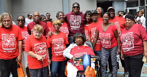 Master P poses with elderly residents who live at Guste Homes in New Orleans, LA