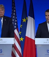 Trump and Macron took questions from reporters in Paris amid a swirl of controversy over his oldest son's meeting with a Russian lawyer.