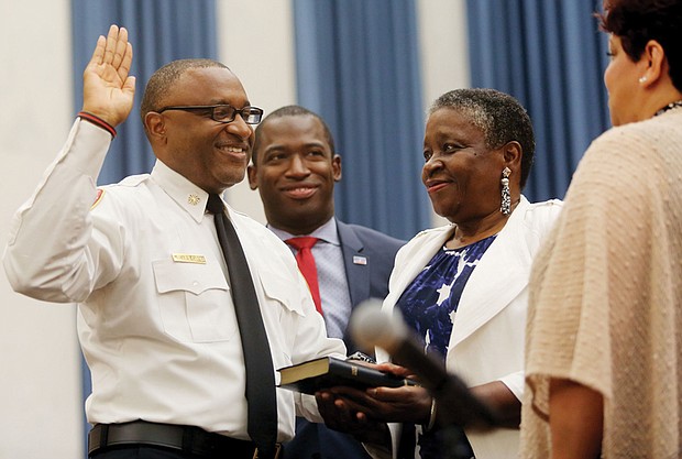 He’s officially on duty //
Melvin D. Carter takes the oath of office Monday as the 21st chief of the Richmond Department of Fire and Emergency Services. His mother proudly holds the Bible as the 54-year-old Richmond native takes the oath of office in the City Council Chamber with Mayor Levar M. Stoney nearby.   