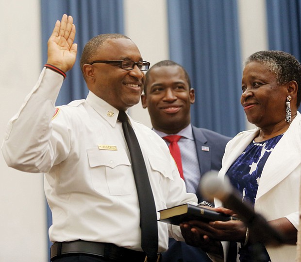 He’s officially on duty //
Melvin D. Carter takes the oath of office Monday as the 21st chief of the Richmond Department of Fire and Emergency Services. His mother proudly holds the Bible as the 54-year-old Richmond native takes the oath of office in the City Council Chamber with Mayor Levar M. Stoney nearby.   