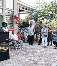 Eggleston Plaza opens // Eggleston Plaza, a new, mixed-use complex with 31 affordable apartments, opens with speeches, applause and a ribbon-cutting ceremony Wednesday in Jackson Ward. The complex at 2nd and Leigh streets is the site of the former Eggleston Hotel. During segregation, the historic hotel served civil rights leaders, famous entertainers and other African-Americans who were barred from other Richmond hotels because of the color of their skin. At the microphone, Kelvin Hanson, the developer and partner in the $6 million project, addresses the crowd, including Neverett A. Eggleston Sr., seated, who owned and operated the Eggleston Hotel, and several Eggleston family members.
