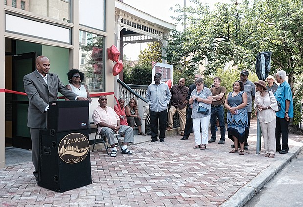 Eggleston Plaza opens // Eggleston Plaza, a new, mixed-use complex with 31 affordable apartments, opens with speeches, applause and a ribbon-cutting ceremony Wednesday in Jackson Ward. The complex at 2nd and Leigh streets is the site of the former Eggleston Hotel. During segregation, the historic hotel served civil rights leaders, famous entertainers and other African-Americans who were barred from other Richmond hotels because of the color of their skin. At the microphone, Kelvin Hanson, the developer and partner in the $6 million project, addresses the crowd, including Neverett A. Eggleston Sr., seated, who owned and operated the Eggleston Hotel, and several Eggleston family members.
