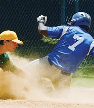 William Gary, right, of the Richmond Blue Sox slides safely into third base despite Duncan McGrath of Riverside covering him during last Sunday’s final in the RBI Tournament in Richmond.