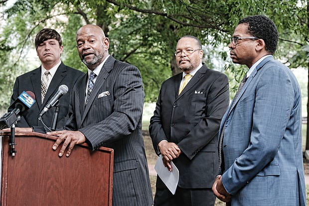 King Salim Khalfani, Richmond managing director for Americans Resisting Minority and Ethnic Discrimination, commends the lawsuit seeking to overturn a state policy of withholding Hepatitis C medicine from inmates. Looking on, from left, are: Michael Donovan, Nexus Services president and CEO, whose company is funding the lawsuit; the Rev. Frank Jackson, managing director of ARMED’s Chicago office; and Mario Williams, lead attorney with Nexus Caridades Attorneys that is representing inmates in the suit.  