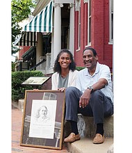Dr. Johnny Mickens III, great-grandson of Maggie L. Walker, and his daughter, Liza, 19, hold a portrait of the Richmond pioneer outside of the Maggie L. Walker National Historic Site at 110½ E. Leigh St. in Jackson Ward where Mrs. Walker lived.