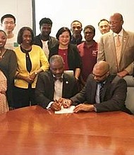 TSU President Austin A. Lane and Eulois Cleckley (HGAC) sign the agreement in the presence of Interim Provost Bobby Wilson, Robert Veazie (HGAC), faculty and students from the Transportation Studies Department.
