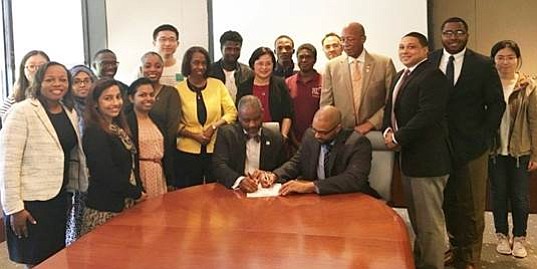 TSU President Austin A. Lane and Eulois Cleckley (HGAC) sign the agreement in the presence of Interim Provost Bobby Wilson, Robert Veazie (HGAC), faculty and students from the Transportation Studies Department.
