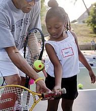 Sayuri Gholson, 6, receives tennis instruction from James Skinner of Midlothian, a volunteer with the Metro Richmond Tennis Club. Above, park visitors take a peek inside the painted tunnel before the unveiling begins