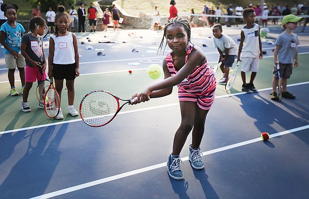 Eye on the ball
Tiffany Smith of Richmond, 6, has her eye on the ball at the Arthur Ashe Tennis Courts in Battery Park. She was among scores of youths who turned out Wednesday, July 12, for the Arthur Ashe Birthday Blast at the park, where they received complimentary tennis lessons and were on hand to celebrate murals created in his honor. A native of Richmond, Mr. Ashe was the first African-American male tennis player to win the U.S. Open, Australian Open and Wimbledon. He was also the first African-American male player to be ranked No. 1. Please see more photos on B2.