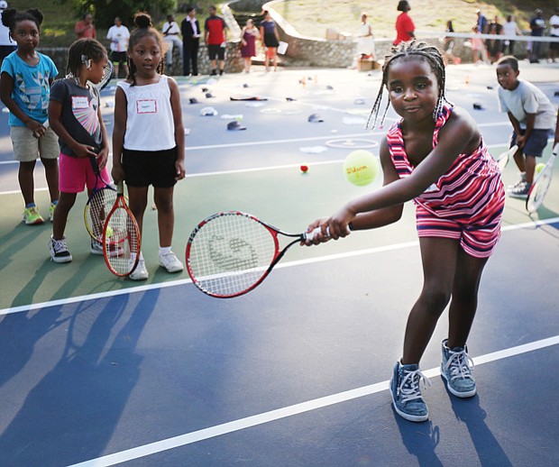 Eye on the ball
Tiffany Smith of Richmond, 6, has her eye on the ball at the Arthur Ashe Tennis Courts in Battery Park. She was among scores of youths who turned out Wednesday, July 12, for the Arthur Ashe Birthday Blast at the park, where they received complimentary tennis lessons and were on hand to celebrate murals created in his honor. A native of Richmond, Mr. Ashe was the first African-American male tennis player to win the U.S. Open, Australian Open and Wimbledon. He was also the first African-American male player to be ranked No. 1. Please see more photos on B2.