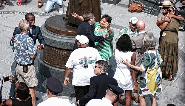 5. City officials, Walker family members, statue sculptor, arts commission members, National Park Service staff and others embrace after the historic unveiling.