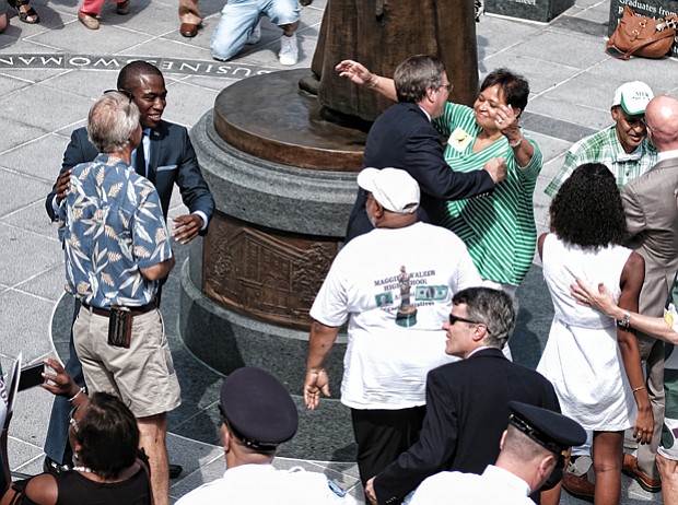5. City officials, Walker family members, statue sculptor, arts commission members, National Park Service staff and others embrace after the historic unveiling.