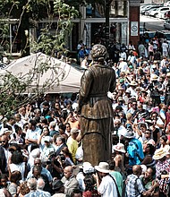 3. The jubilant crowd encircles the statue for a closer look and photos after the ceremony.